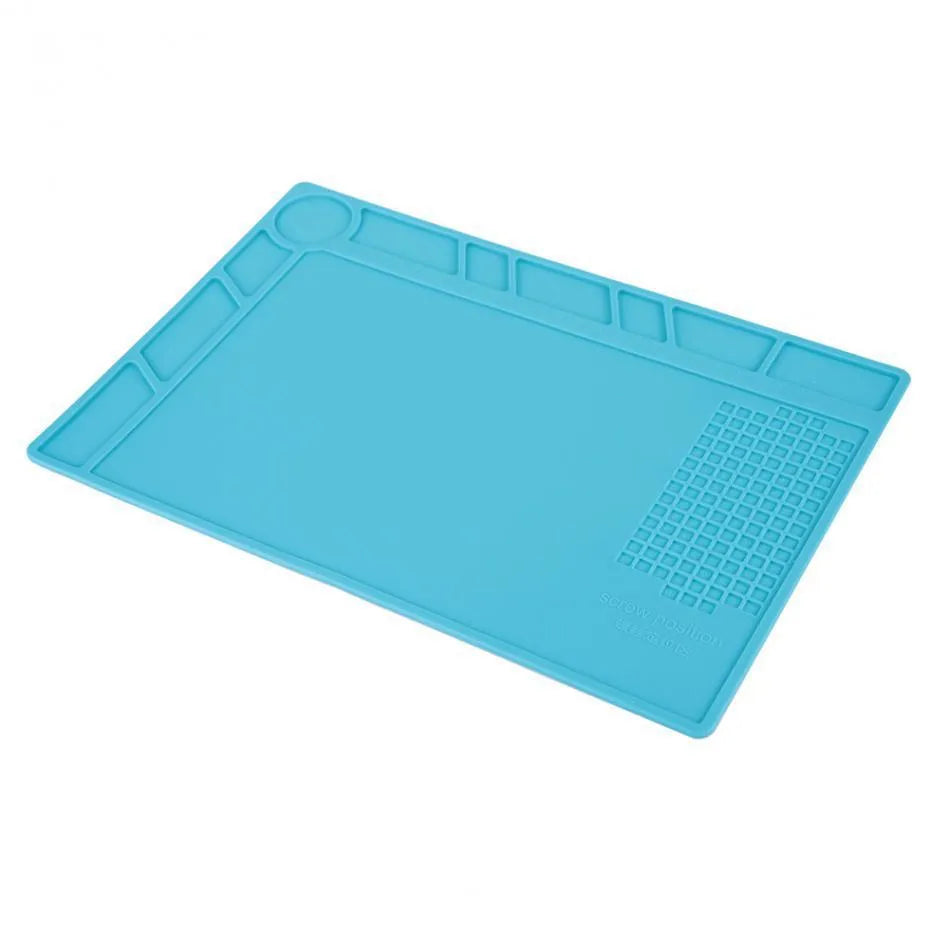Blue silicone anti-skid watch repair mat lying flat on a workbench.