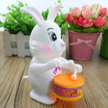 Cartton white plastic rabbit drumming clockwork wind-up toy on white background, 6x13cm