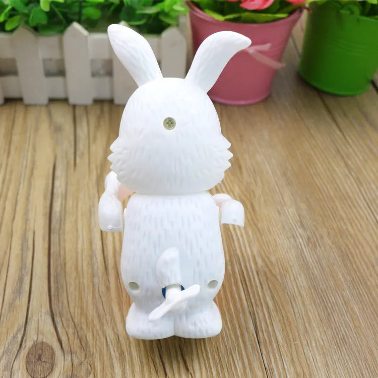Cartton white plastic rabbit drumming clockwork wind-up toy on white background, 6x13cm
