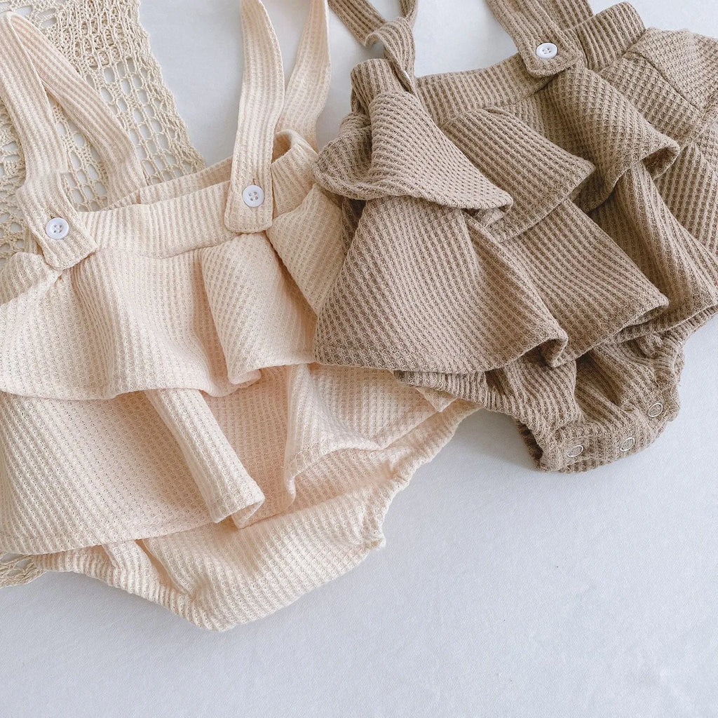 Baby girl in a pleated lotus leaf style cotton romper, triangle climb suit design for 0-2 year olds.