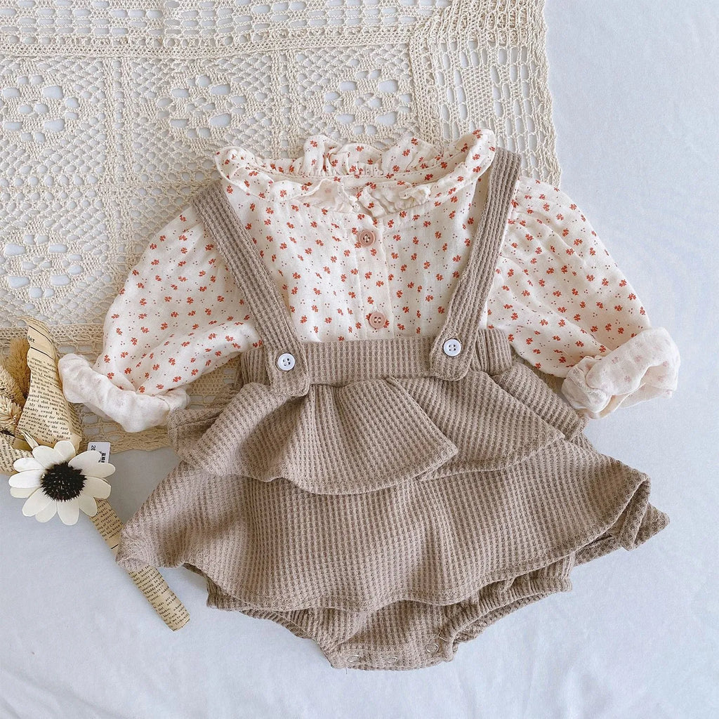 Baby girl in a pleated lotus leaf style cotton romper, triangle climb suit design for 0-2 year olds.