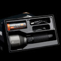 Black rechargeable outdoor flashlight showing aluminium construction with measurement indicators