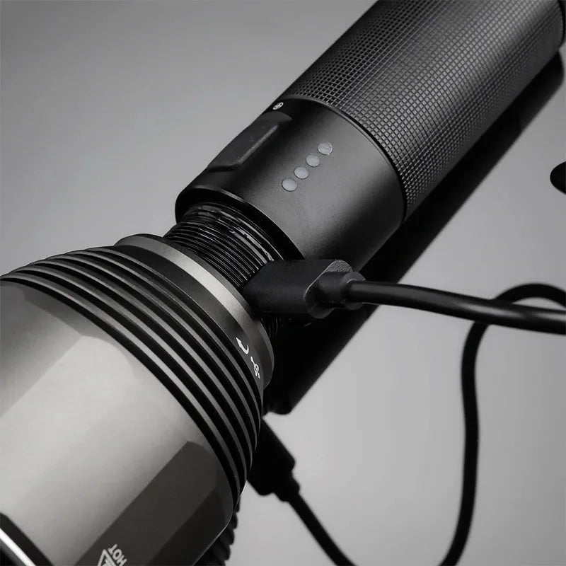 Black rechargeable outdoor flashlight showing aluminium construction with measurement indicators
