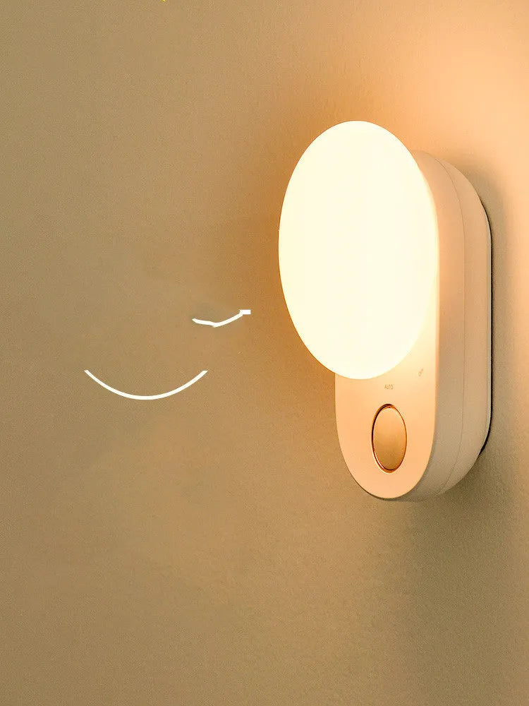 White Baseus Sunshine Series rechargeable LED night light with motion sensor on a bedside table.