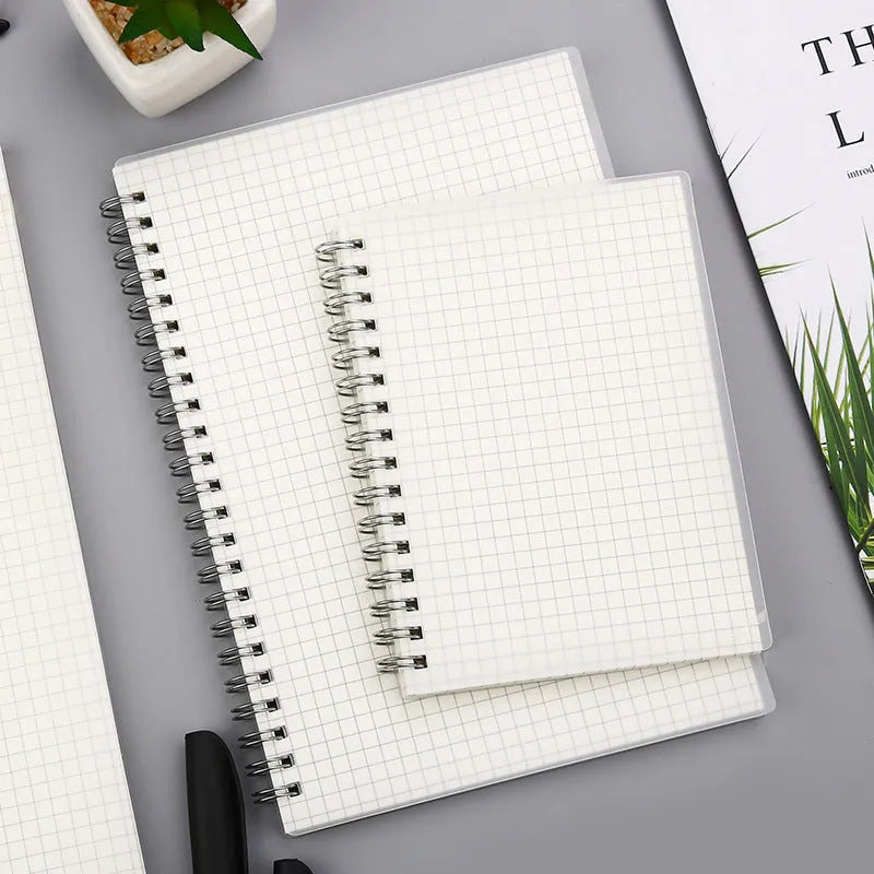 Creative coil-bound notebook open showing grid dot matrix pages, with PP matte cover in A5 size.