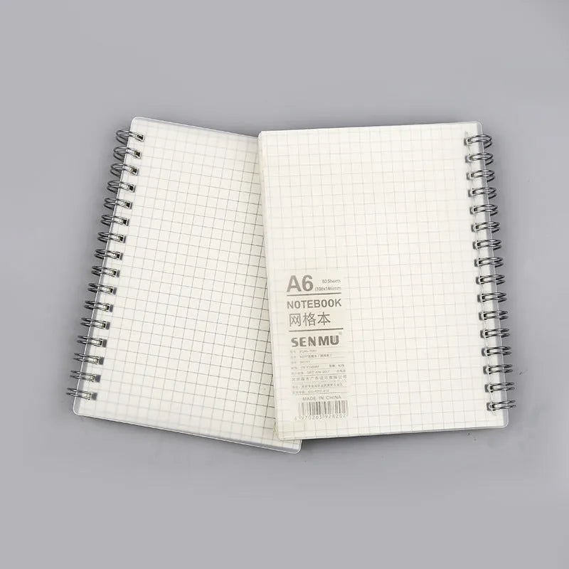 Creative coil-bound notebook open showing grid dot matrix pages, with PP matte cover in A5 size.