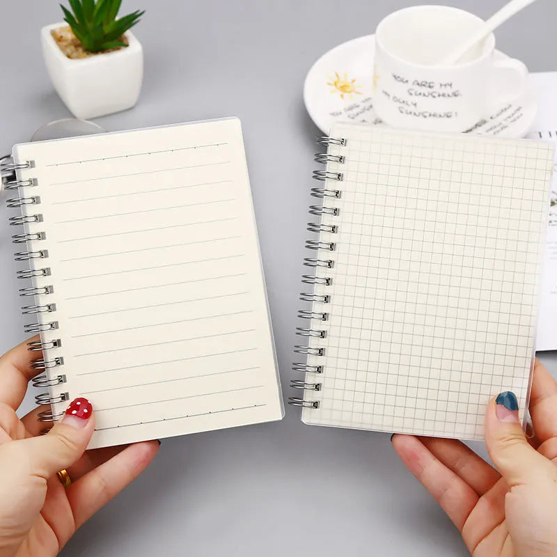 Creative coil-bound notebook open showing grid dot matrix pages, with PP matte cover in A5 size.
