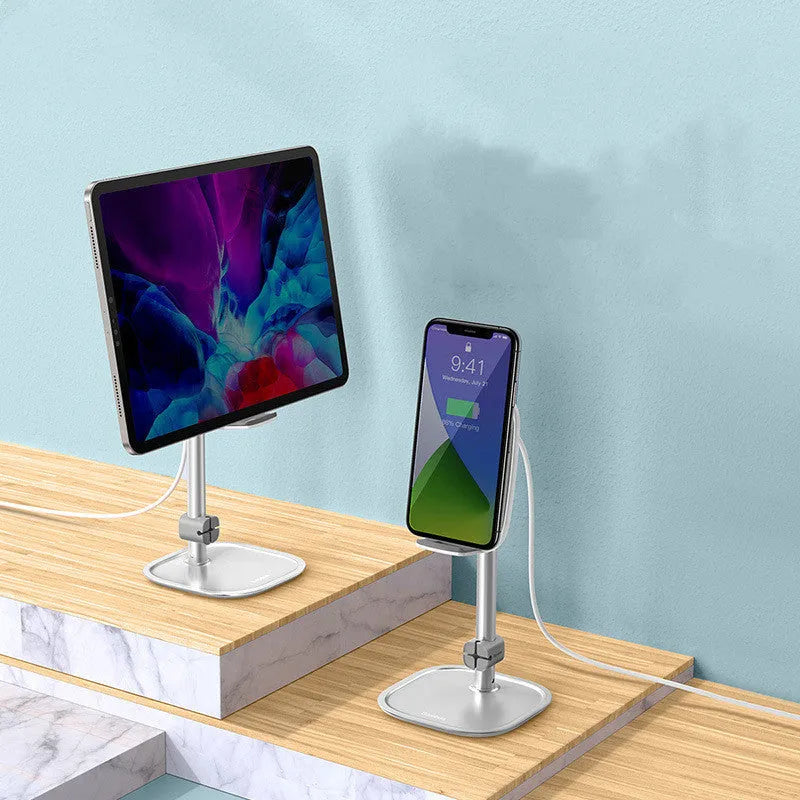 Baseus 15W wireless charger stand in silver holding a smartphone on a desk