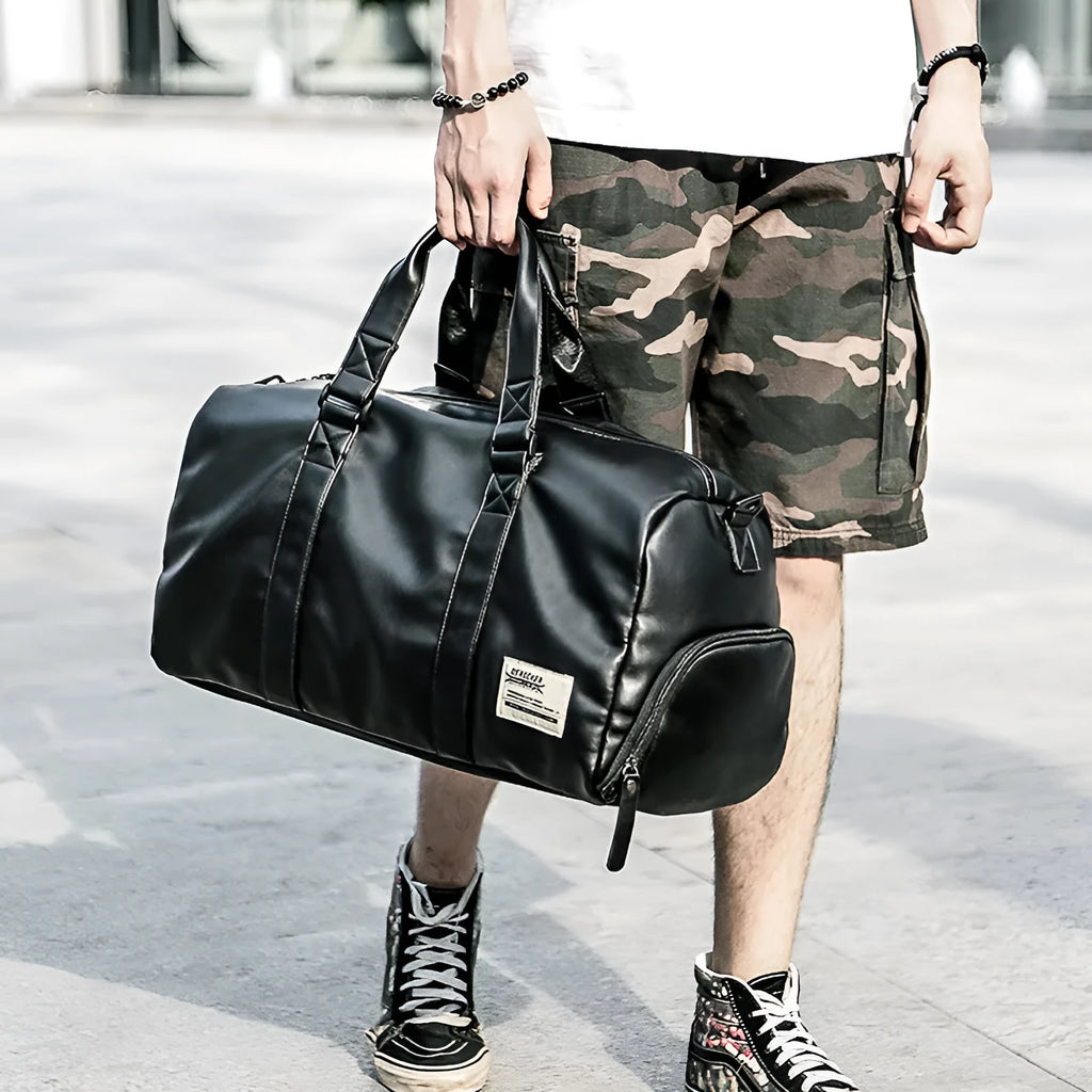Large black waterproof PU leather sports training bag with multiple pockets and a breathable back panel.
