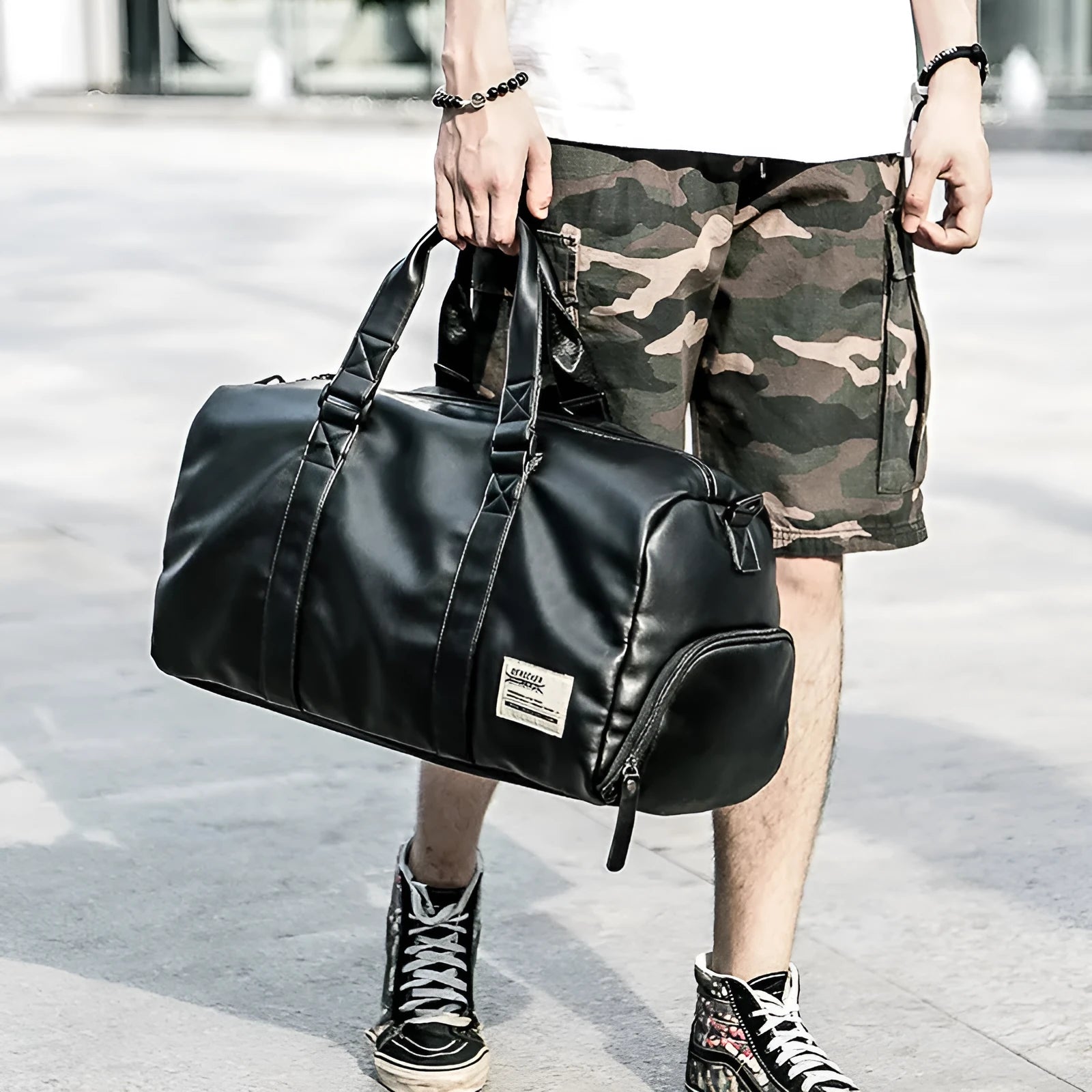 Large black waterproof PU leather sports training bag with multiple pockets and a breathable back panel.