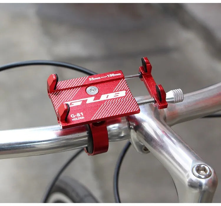Aluminium bicycle phone holder mounted on a handlebar, showing a smartphone secured in the 360-degree rotating clamp.