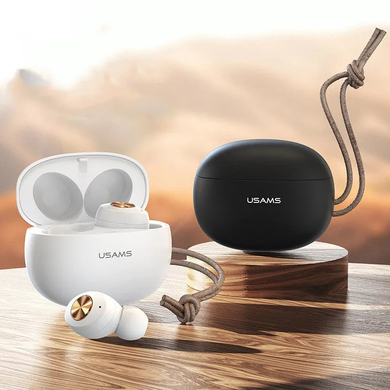 Pebble Series mini wireless Bluetooth earbuds and charging case in black, placed on a white surface.