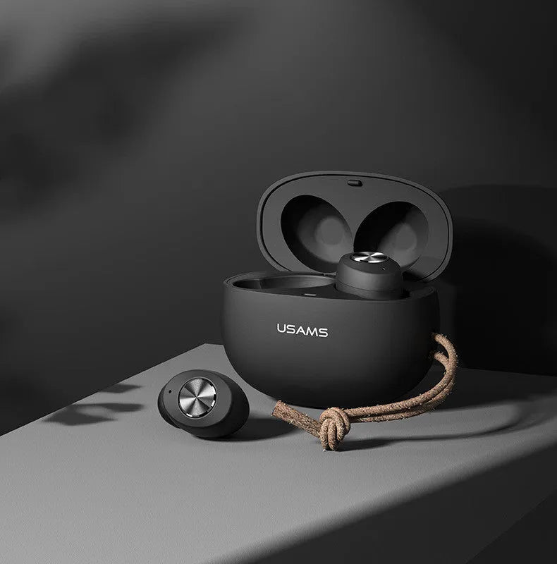 Pebble Series mini wireless Bluetooth earbuds and charging case in black, placed on a white surface.