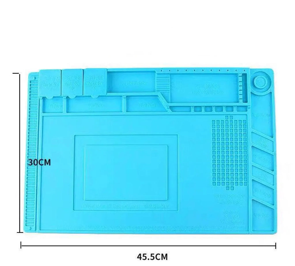 Blue silicone magnetic heat insulation repair pad 45.5 by 30 cm on a desk with repair tools