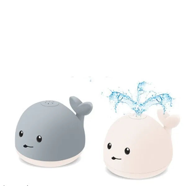 Grey and white whale bath toy with water spray, LED lights, floating in water