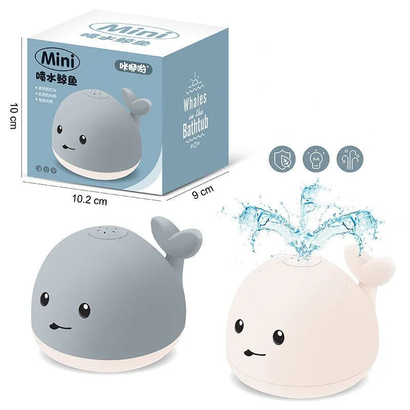Grey and white whale bath toy with water spray, LED lights, floating in water
