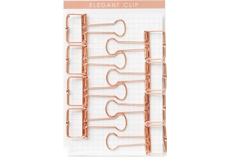 Rose gold metal binder set with eight small and six large folders for tickets and papers.
