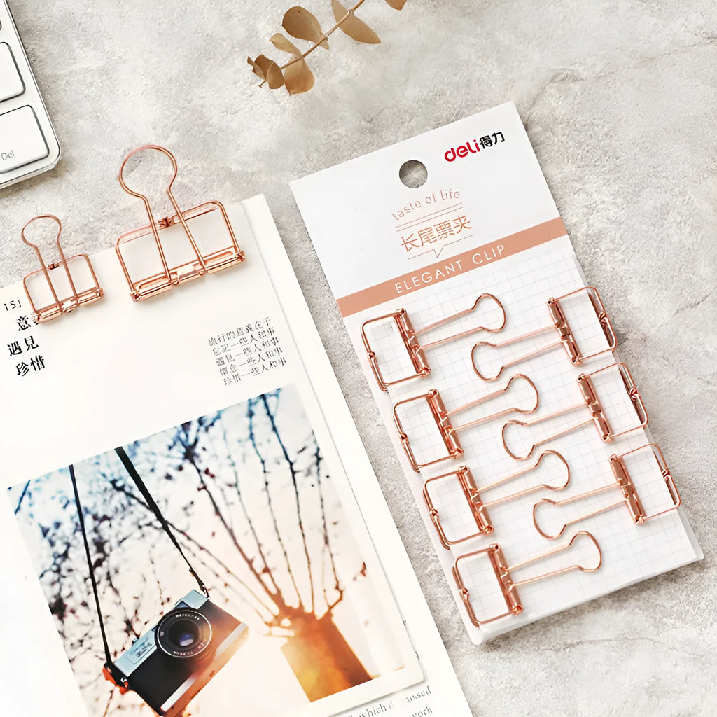 Rose gold metal binder set with eight small and six large folders for tickets and papers.