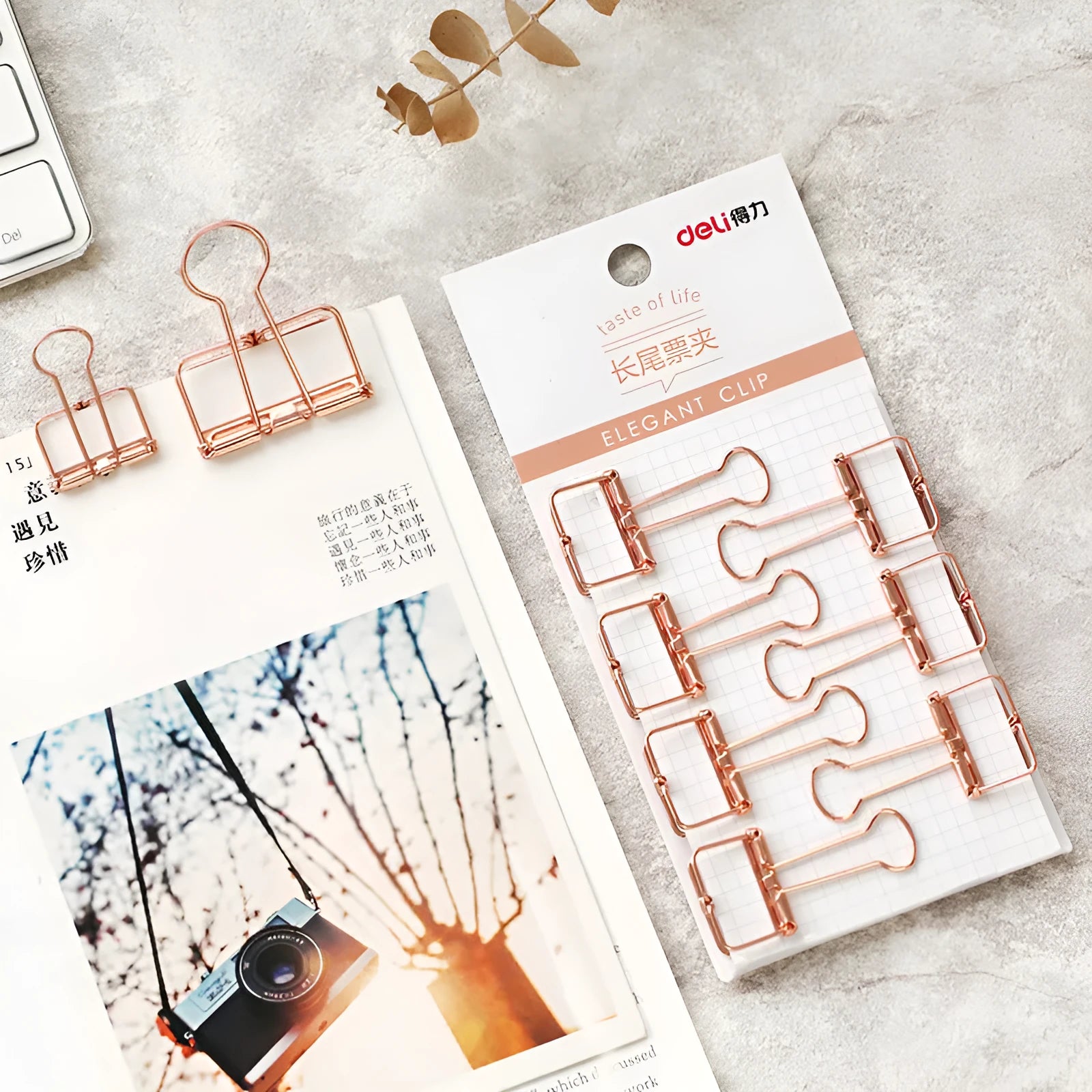 Rose gold metal binder set with eight small and six large folders for tickets and papers.