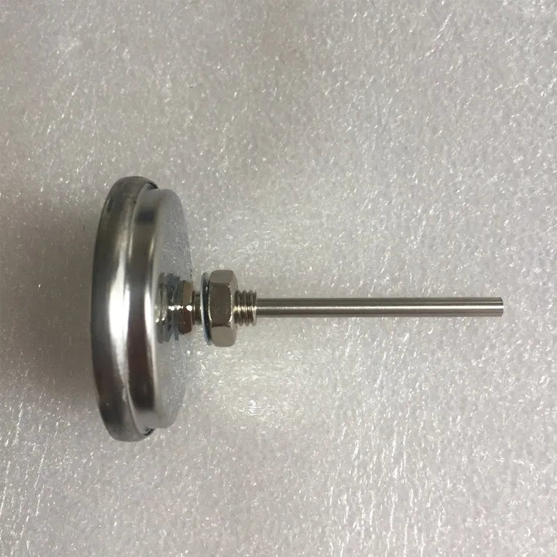 Bimetal oven thermometer with large glass dial showing temperature markings, metal probe, on a neutral background