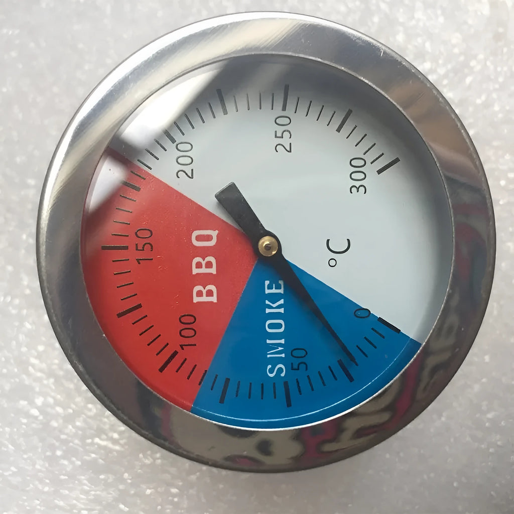 Bimetal oven thermometer with large glass dial showing temperature markings, metal probe, on a neutral background
