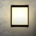 Square outdoor LED wall light with aluminium housing, shown mounted on a wall.