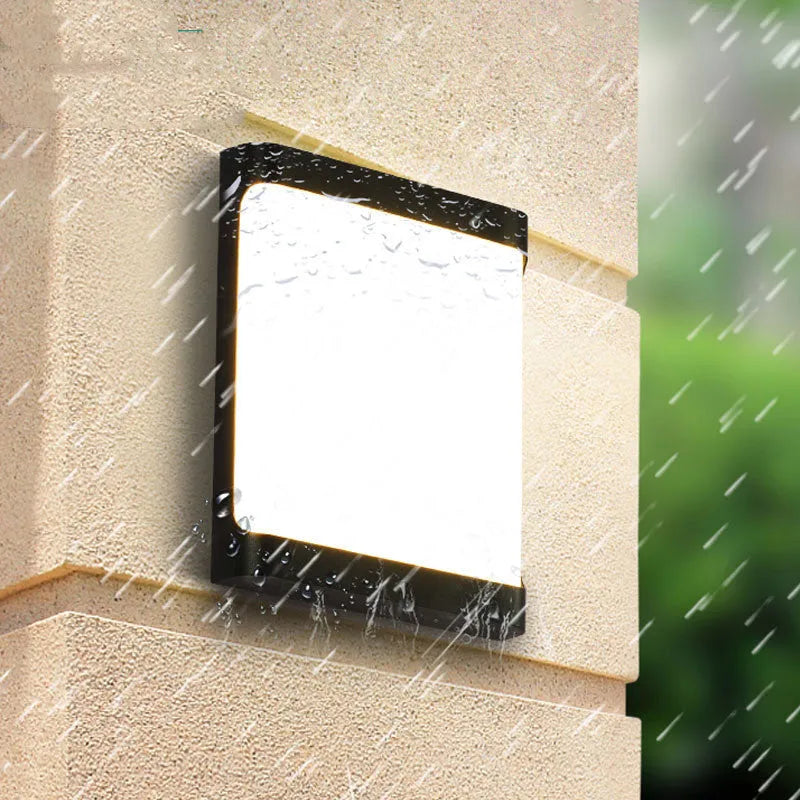 Square outdoor LED wall light with aluminium housing, shown mounted on a wall.