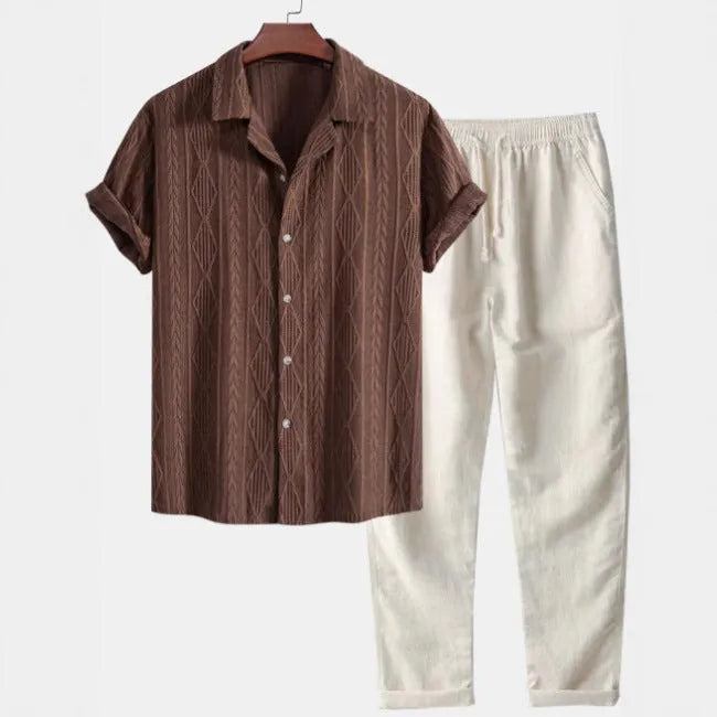Casual linen suit set with camouflage print, featuring a short-sleeved top and matching trousers.