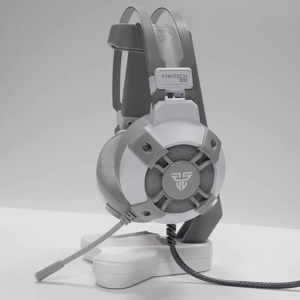 Black FANTECH HG11 USB gaming headset with over-ear cups and RGB lighting on a stand.