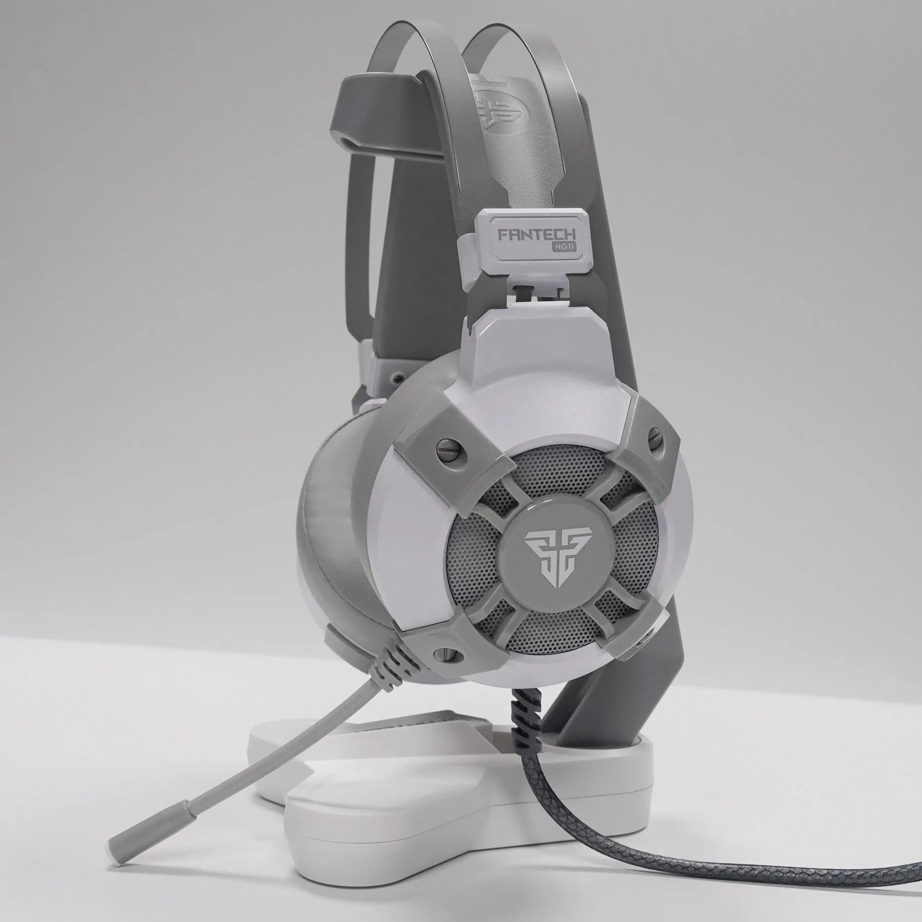 Black FANTECH HG11 USB gaming headset with over-ear cups and RGB lighting on a stand.