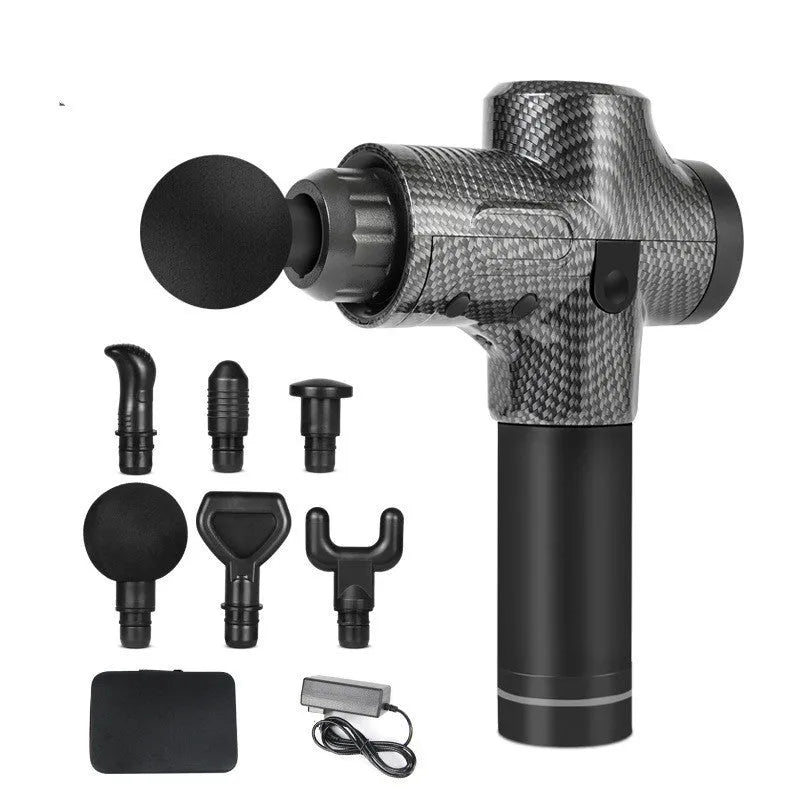 Black electric muscle massage gun with 7 different attachment heads on a table.
