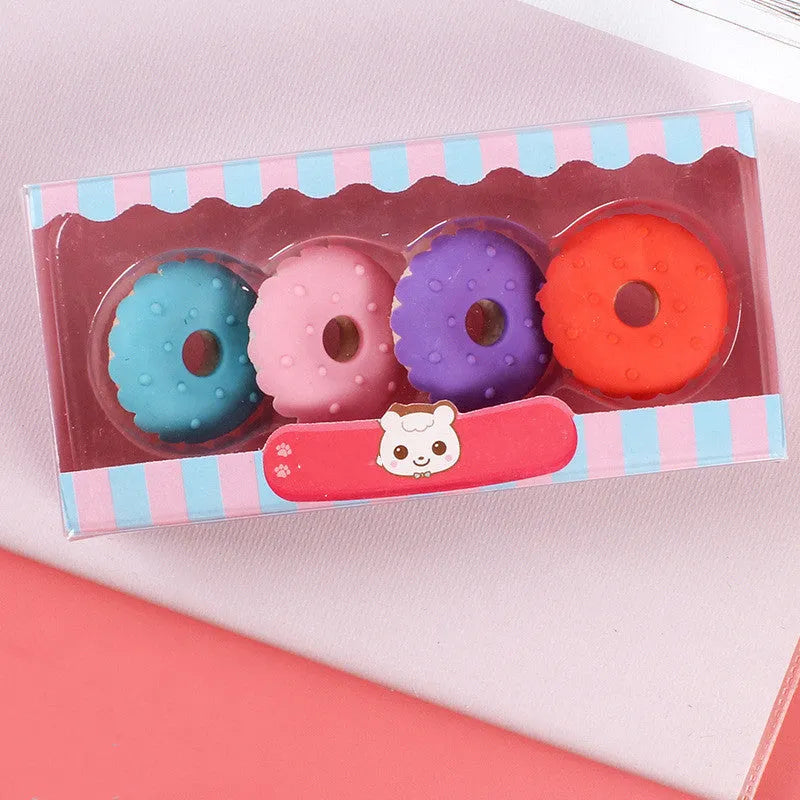 Assortment of 12 colourful cartoon erasers shaped like ice cream, lollipops, doughnuts, and cones for children.
