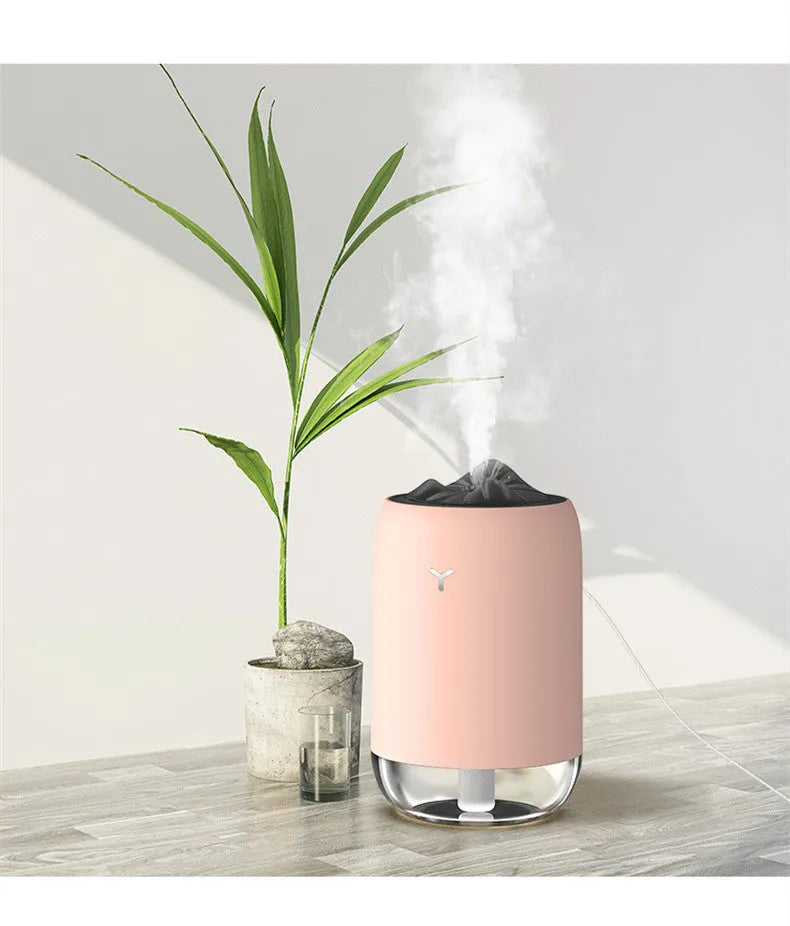 Magic Flame ultrasonic mini humidifier in white, blue, and pink colours on a desktop