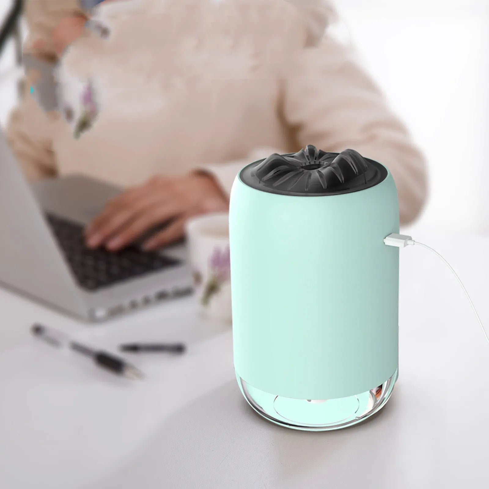 Magic Flame ultrasonic mini humidifier in white, blue, and pink colours on a desktop