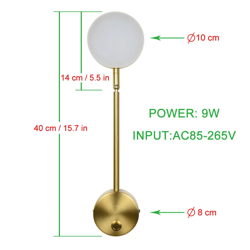 Gold LED wall lamp with rotary switch and acrylic shade on a wall