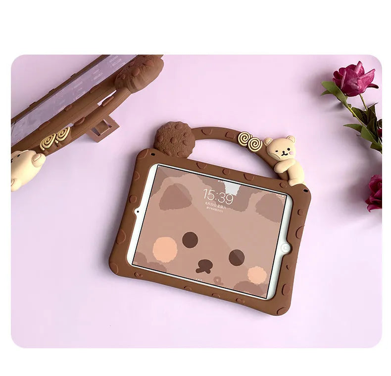 Brown cartoon-style silicone sleeve for iPad with a bracket handle, shown on a tablet.