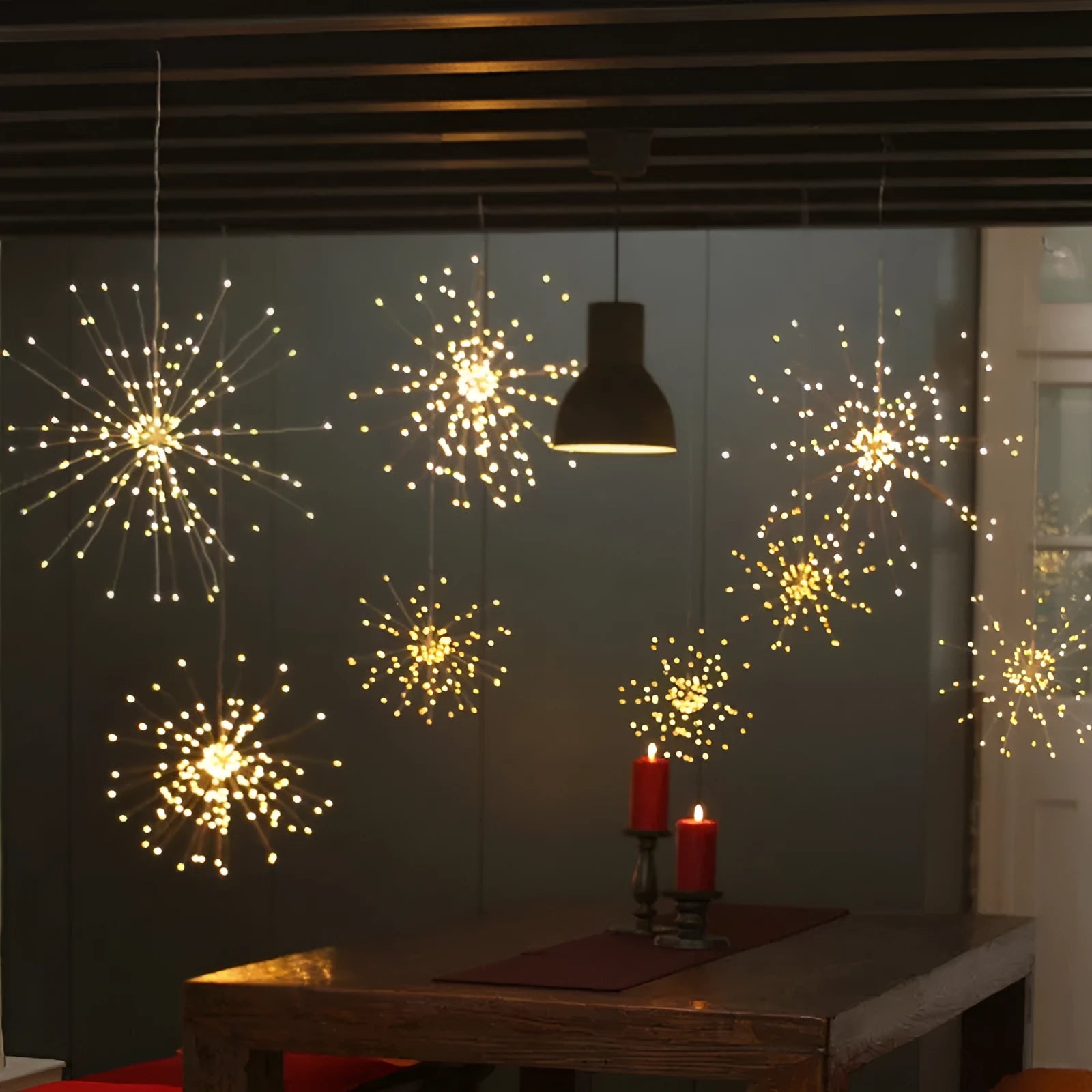 Solar-powered LED meteor shower string lights creating starry explosion effect in warm white colour