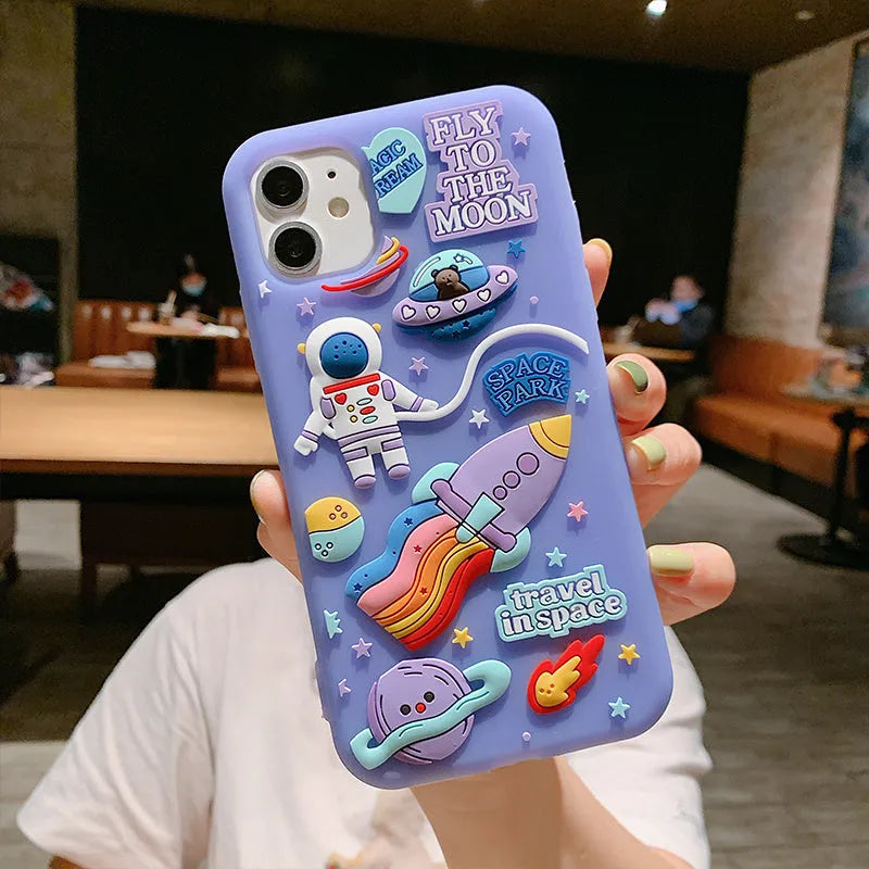 Purple silicone iPhone case with a cartoon astronaut graphic, showing front and back views.