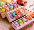 Assortment of 12 colourful cartoon erasers shaped like ice cream, lollipops, doughnuts, and cones for children.