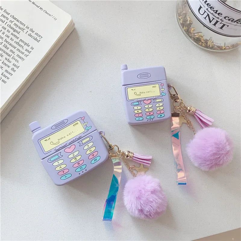Purple silicone protective case for Apple AirPods with a white fur ball pendant attached.