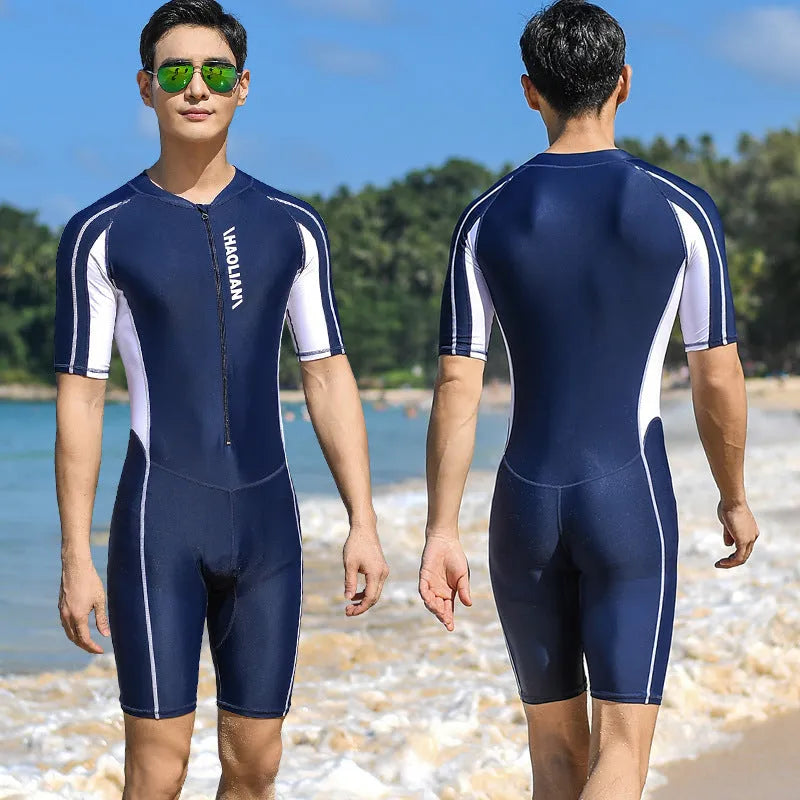 Men's short-sleeved neoprene surfing suit with front zip, in black, shown on a model.