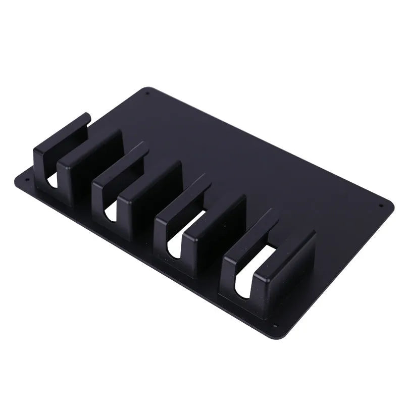 Black plastic wall-mounted rack holding four electric hair clippers.