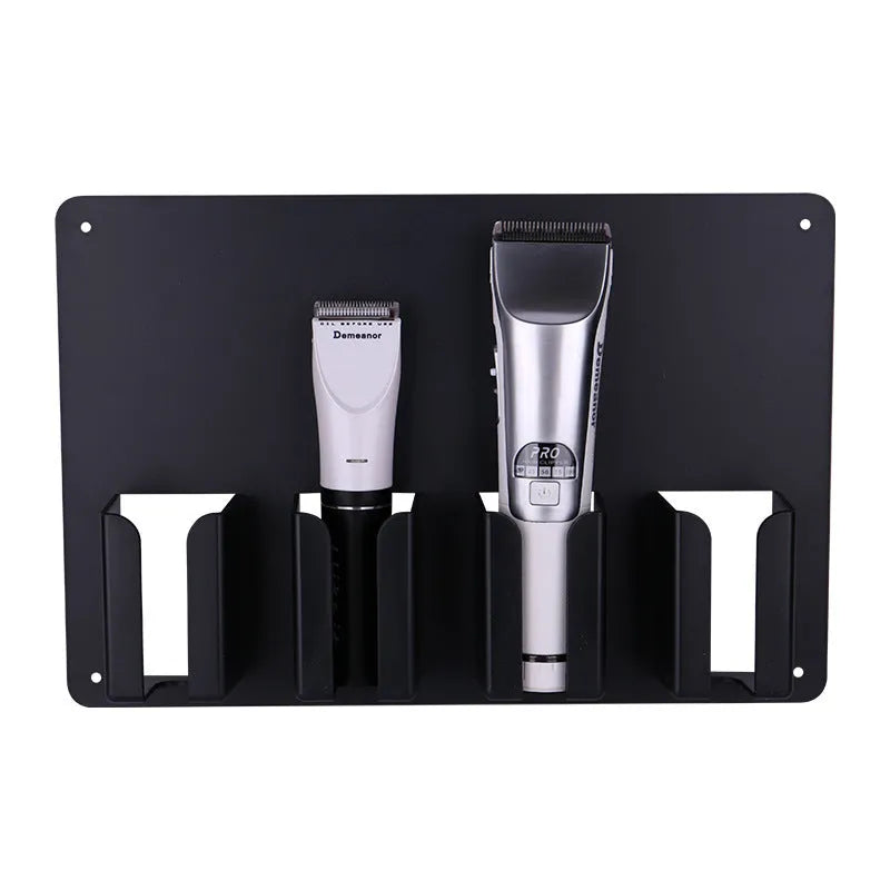 Black plastic wall-mounted rack holding four electric hair clippers.