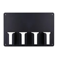 Black plastic wall-mounted rack holding four electric hair clippers.