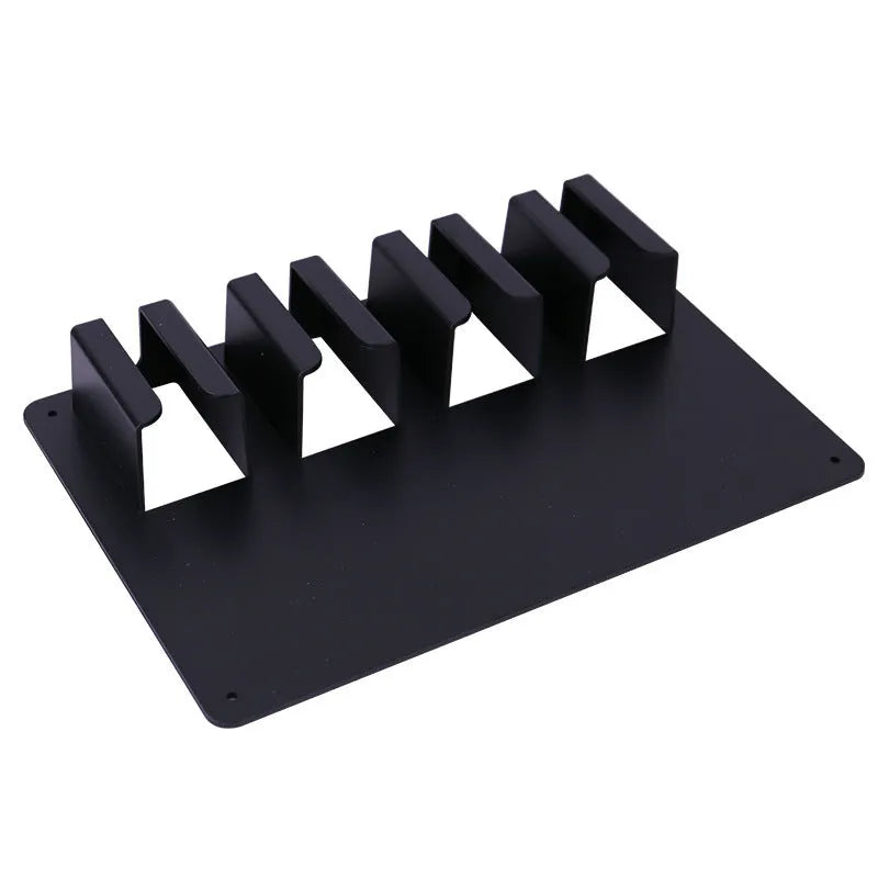 Black plastic wall-mounted rack holding four electric hair clippers.