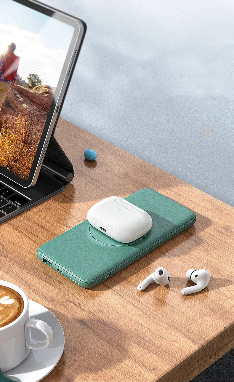 Mint green magnetic wireless power bank with back clip, shown next to a compatible iPhone.