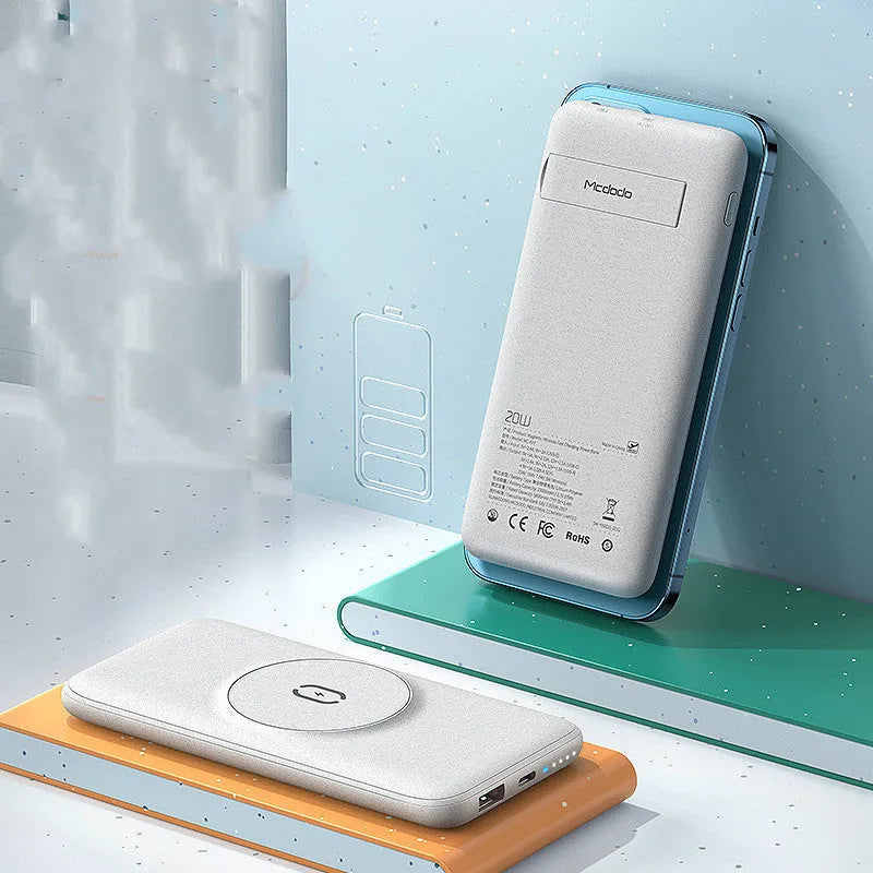 Mint green magnetic wireless power bank with back clip, shown next to a compatible iPhone.