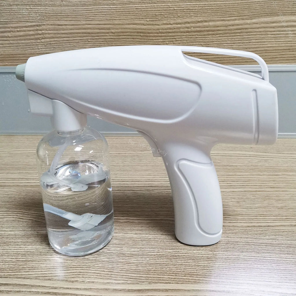 White handheld cordless electric spray gun with USB-C charging port on a plain background.