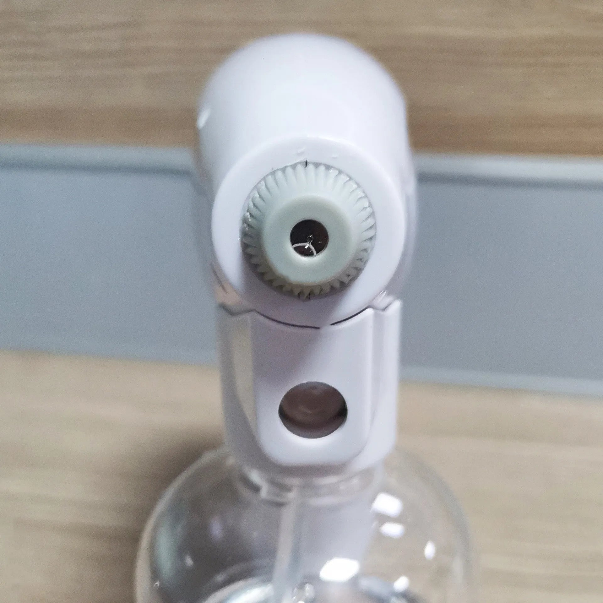 White handheld cordless electric spray gun with USB-C charging port on a plain background.