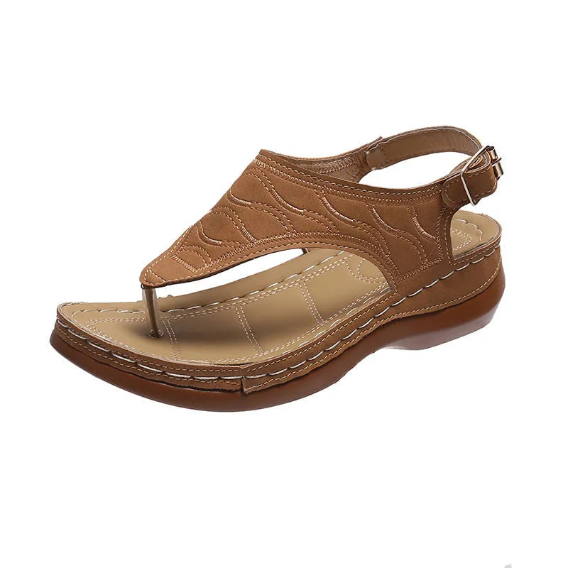 Women's red casual wedge heel sandals with an adjustable buckle strap on a white background.